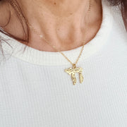 Love Lisa Chai to Life necklace worn on neck in gold with engraved symbolic Chai pendant on delicate chain