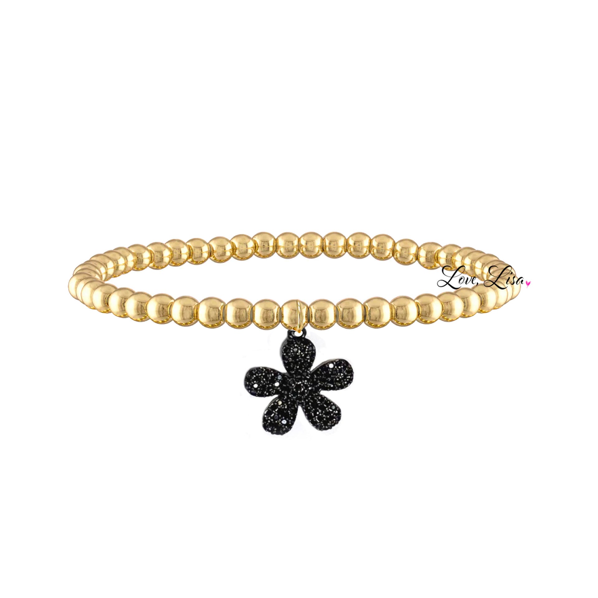 A gold-colored bracelet featuring a floral charm with black accents on a white background.