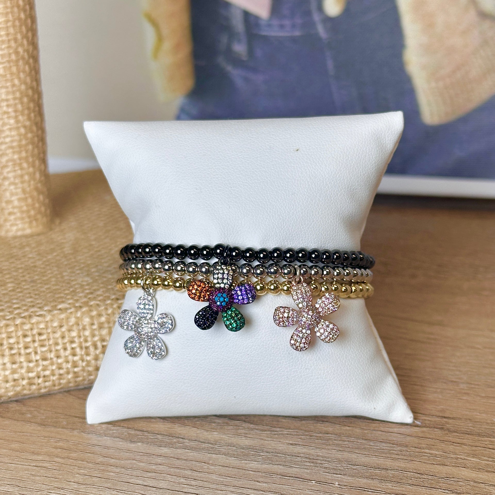 Charlotte Flower Charm Bracelet with crystal flower charm on stretch beaded bracelet in black, gold, and silver