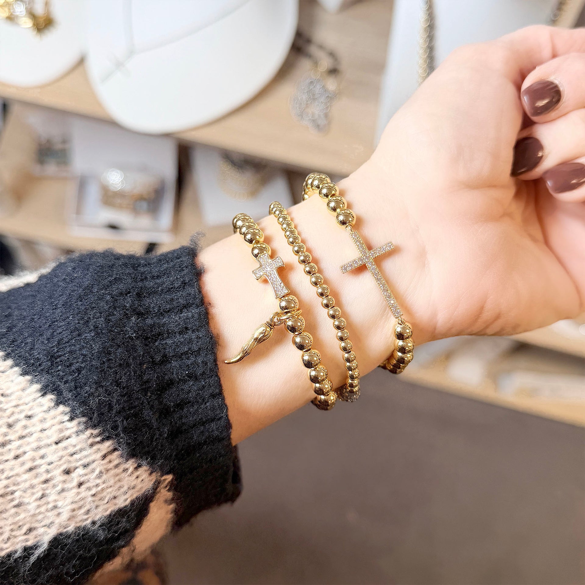 love lisa christine italian horn cornicello cross bracelet lifestyle photo gold style stacked with other bracelets