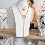 Ava clover gold  necklace on a display