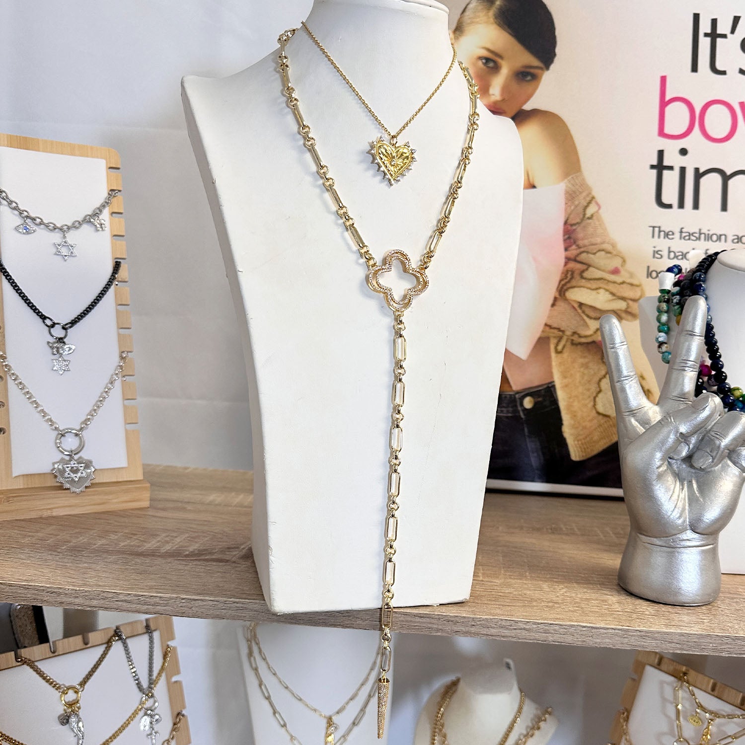 Ava clover gold  necklace on a display