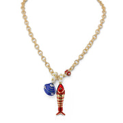 Coastal Catch Fish Charm Necklace in red with gold chain enamel fish charm crystal shell charm and evil eye accent