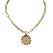A gold link chain necklace with a circular bee coin pendant.