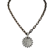 A gunmetal link chain necklace with a circular bee coin pendant.