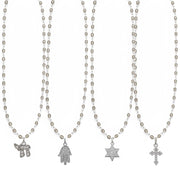 Set of four necklaces with various pendants on a white background