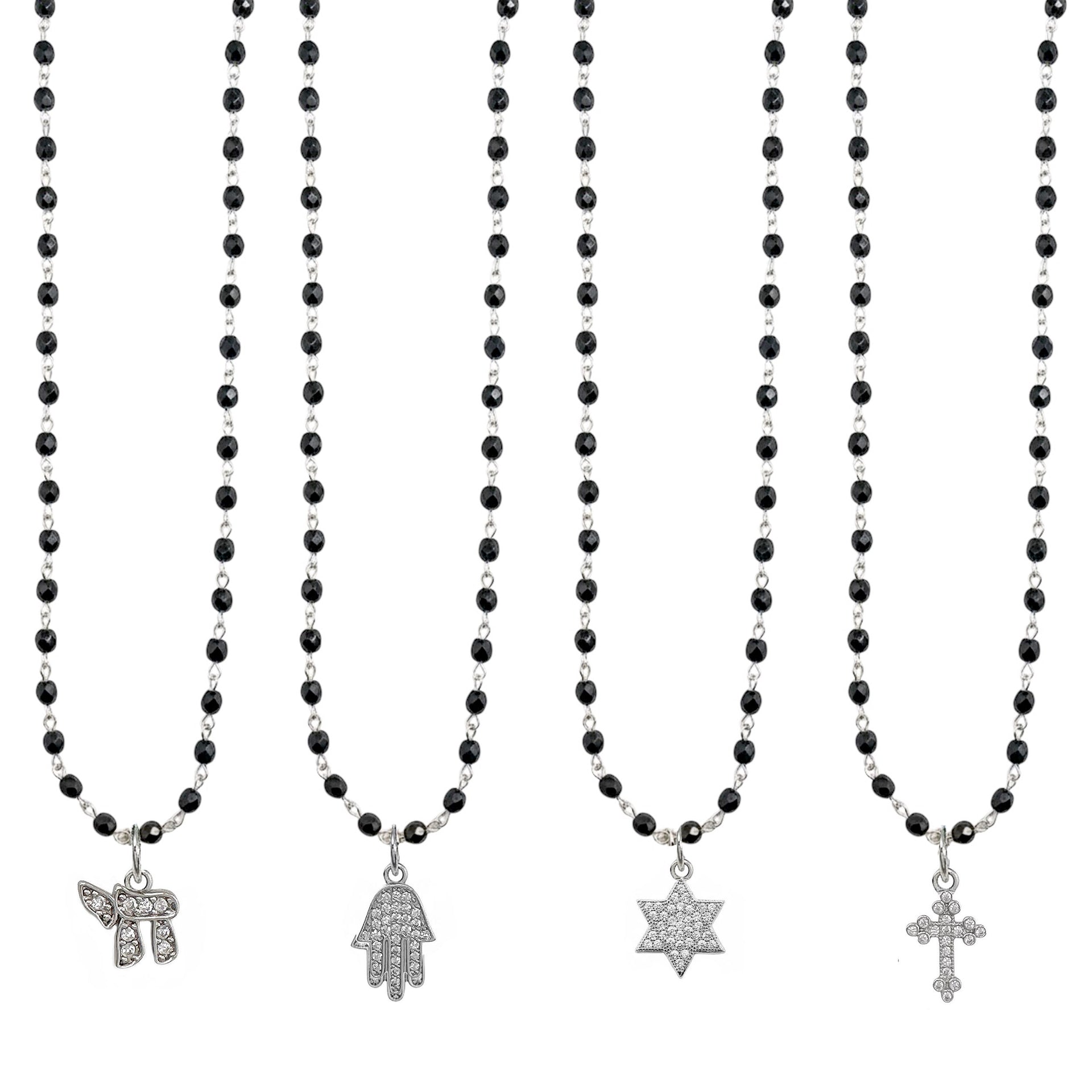 Set of black beaded necklaces with various pendants on a white background