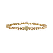 Gold beaded bracelet with a clasp on a white background