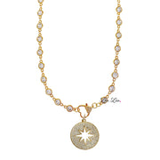 Celestial gold starburst pendant with shimmering details on necklace