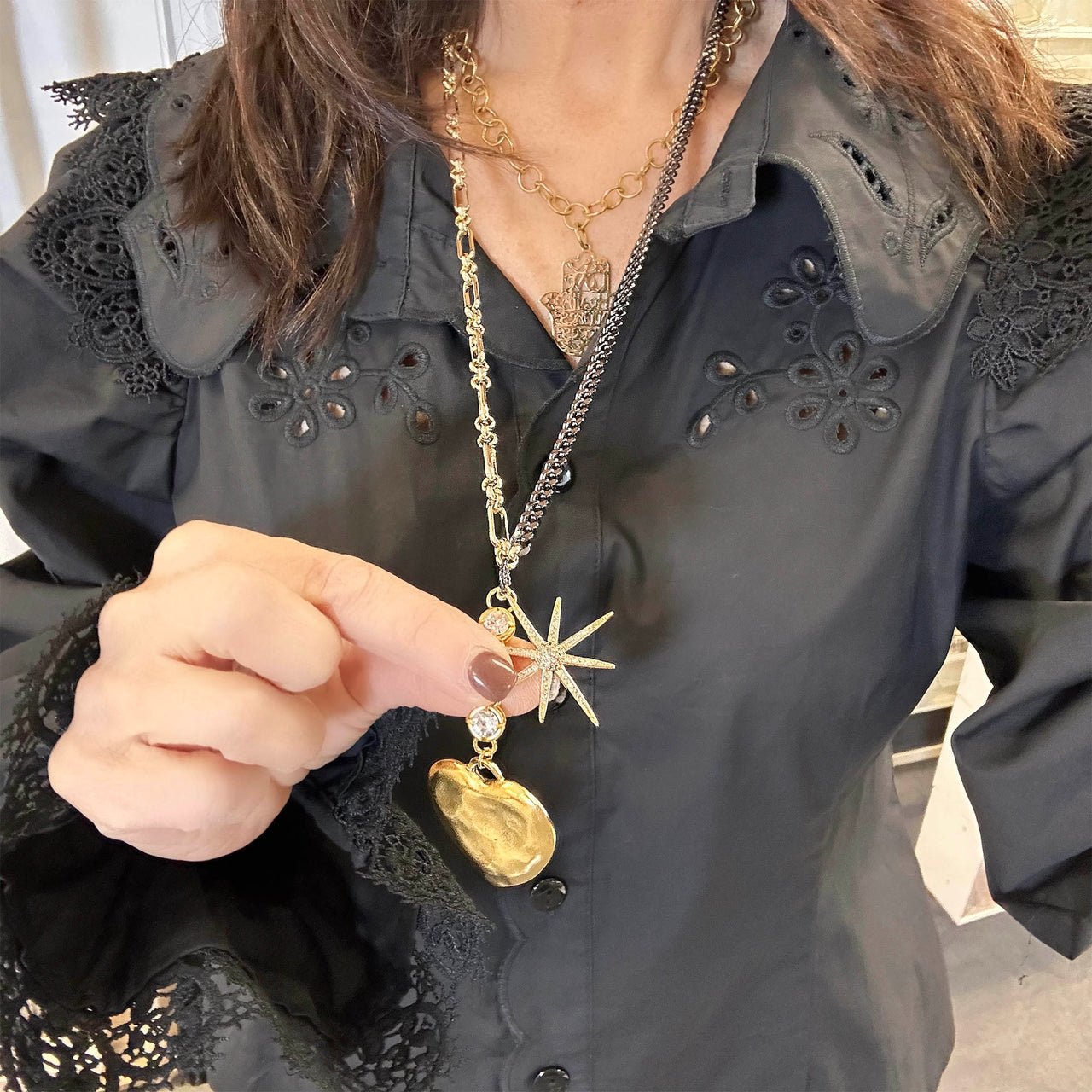 woman wearing gold eclipse pendant long necklace heart charm Love Lisa