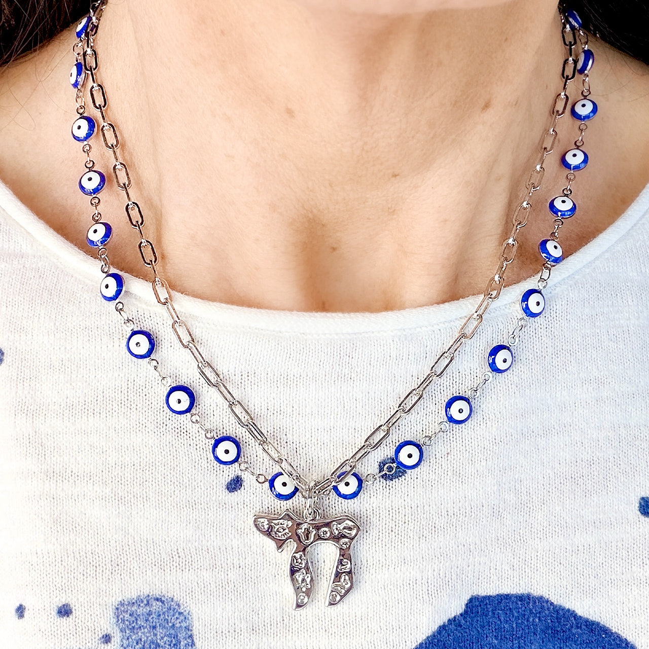 Love Lisa Eden chai evil eye necklace worn showing layered chains and collarbone fit
