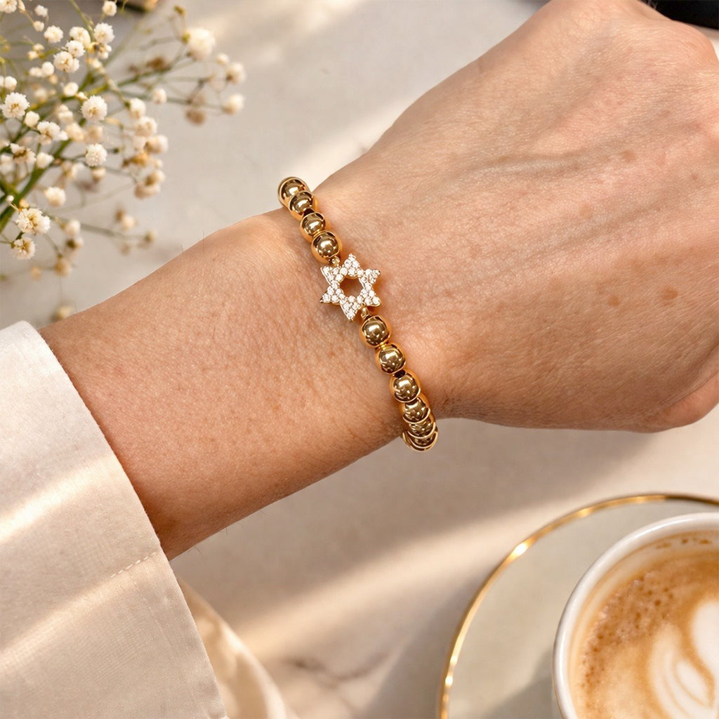 Close-up of a wrist wearing multiple bracelets with a blurred background