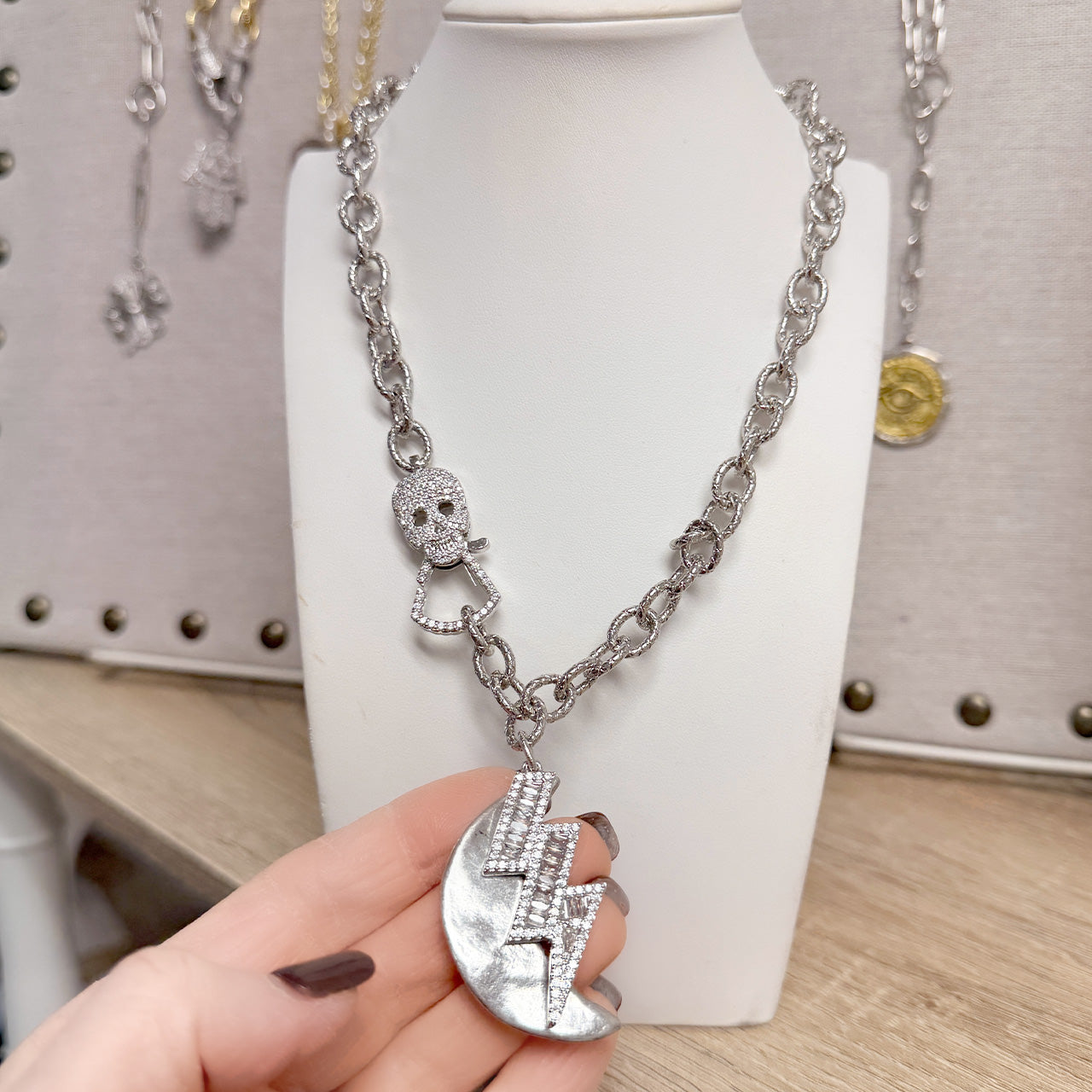 Love Lisa skull clasp necklace with crescent moon charm and crystal lightning bolt detail