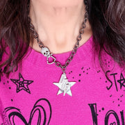 Love Lisa skull clasp statement necklace styled on model with star charm and crystal lightning bolt