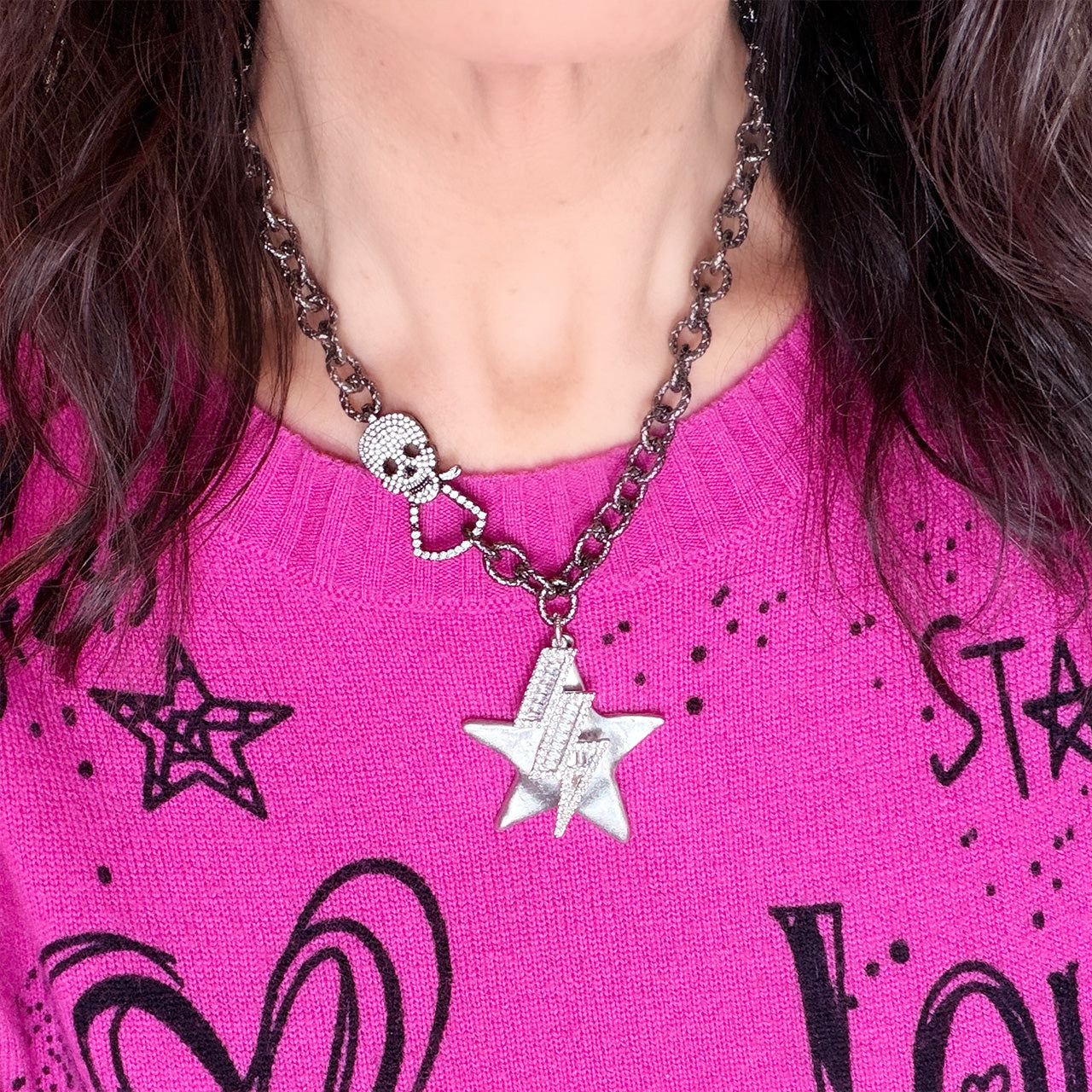 Love Lisa skull clasp statement necklace styled on model with star charm and crystal lightning bolt