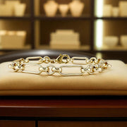 Gold chain bracelet on a beige cushion with a blurred jewelry store background