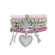 Emmy Heart Bracelet Stack misty rose and silver stretch bracelets with pavé hearts love and bow charms