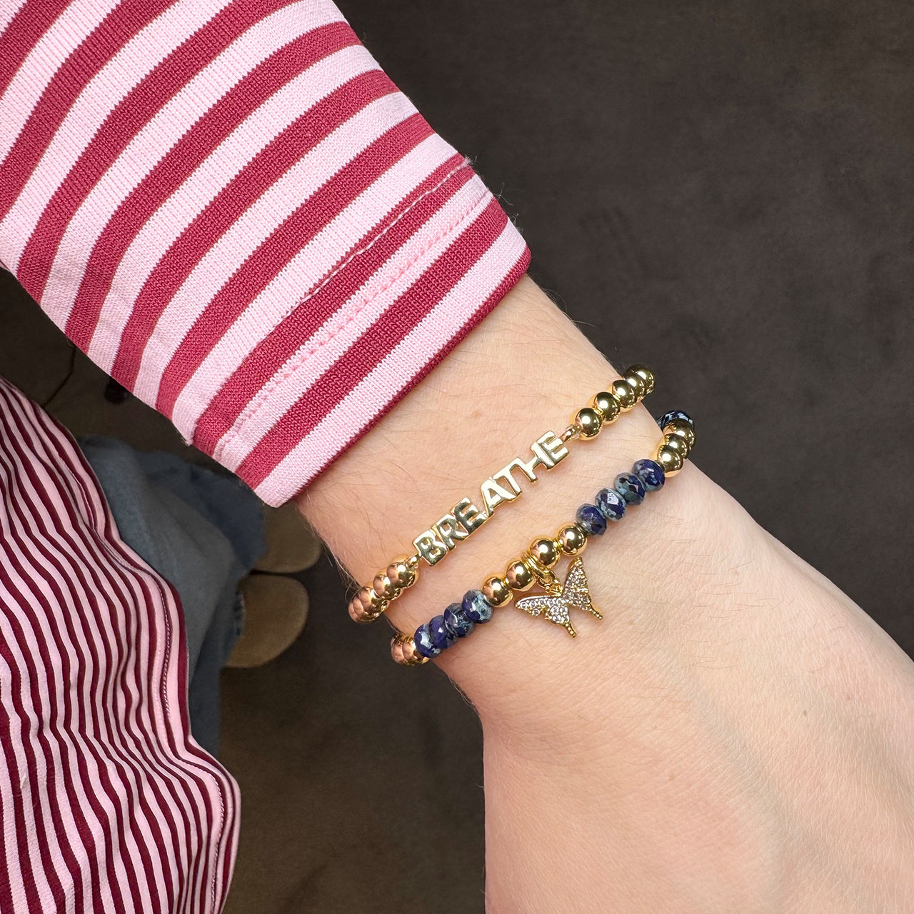 gold empowerment butterfly bracelets stacked