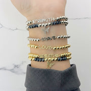 silver and gold empowerment butterfly bracelets stacked together love lisa jewelry