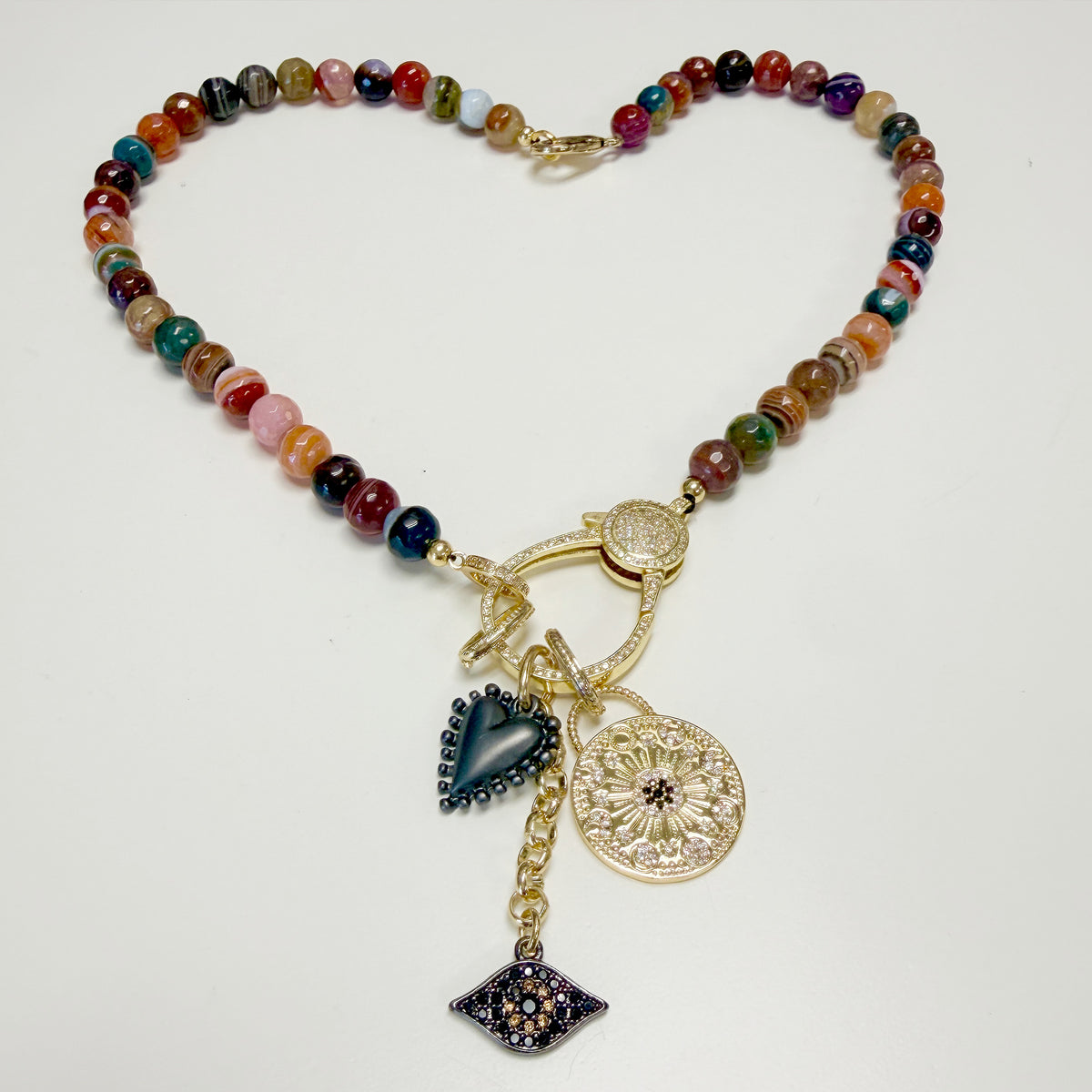 Full view of Love Lisa Estelle Gemstone Charm Necklace with faceted mixed agate beads, celestial medallion, dimensional heart, sparkling evil eye, and mixed-metal details