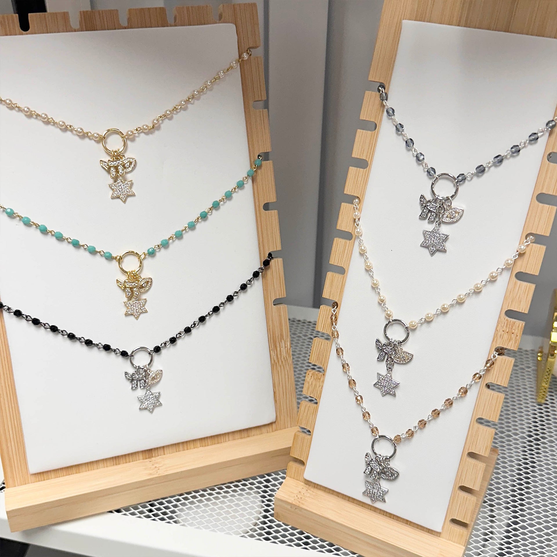 Eternal Chai Necklaces by Love Lisa displayed on jewelry stand in multiple bead colors