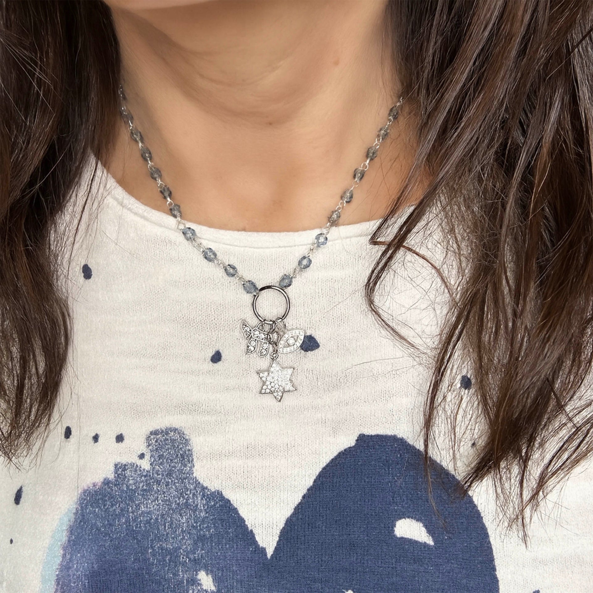 Eternal Chai Necklace by Love Lisa worn layered on model with chai evil eye and star of david charms
