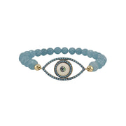 Bracelet with blue beads and an eye-shaped charm on a white background