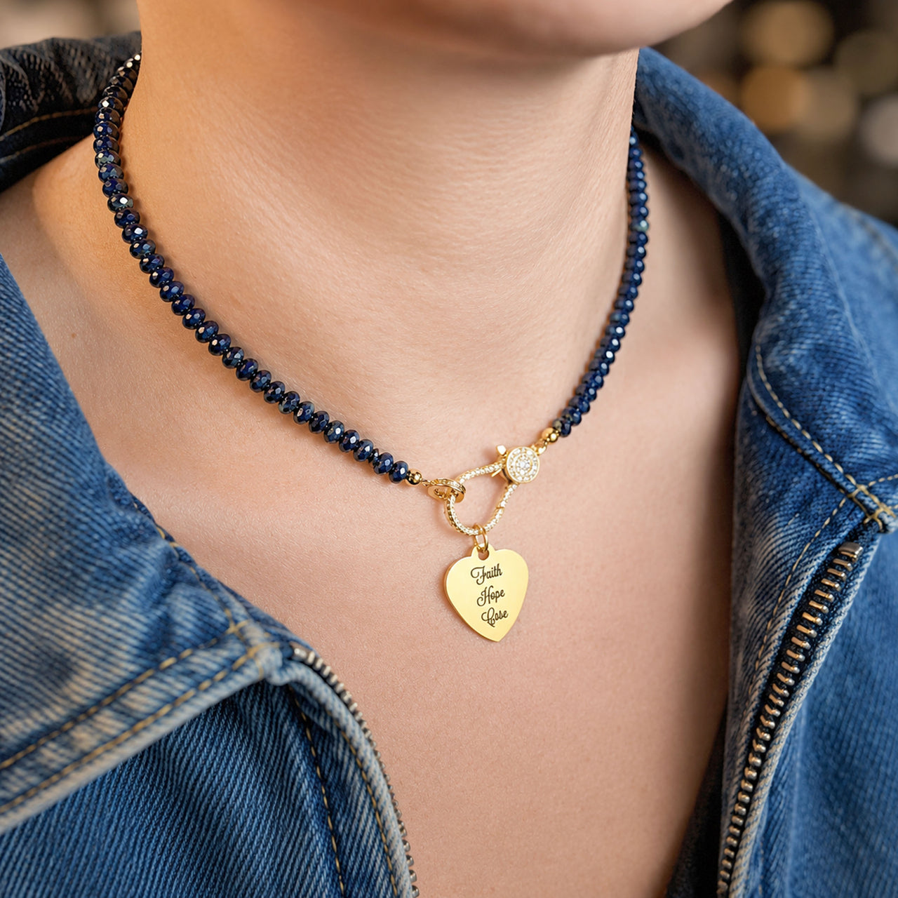 Love Lisa Faith Hope Cure T1D awareness necklace worn on neck with navy rondelle beaded necklace and gold heart charm