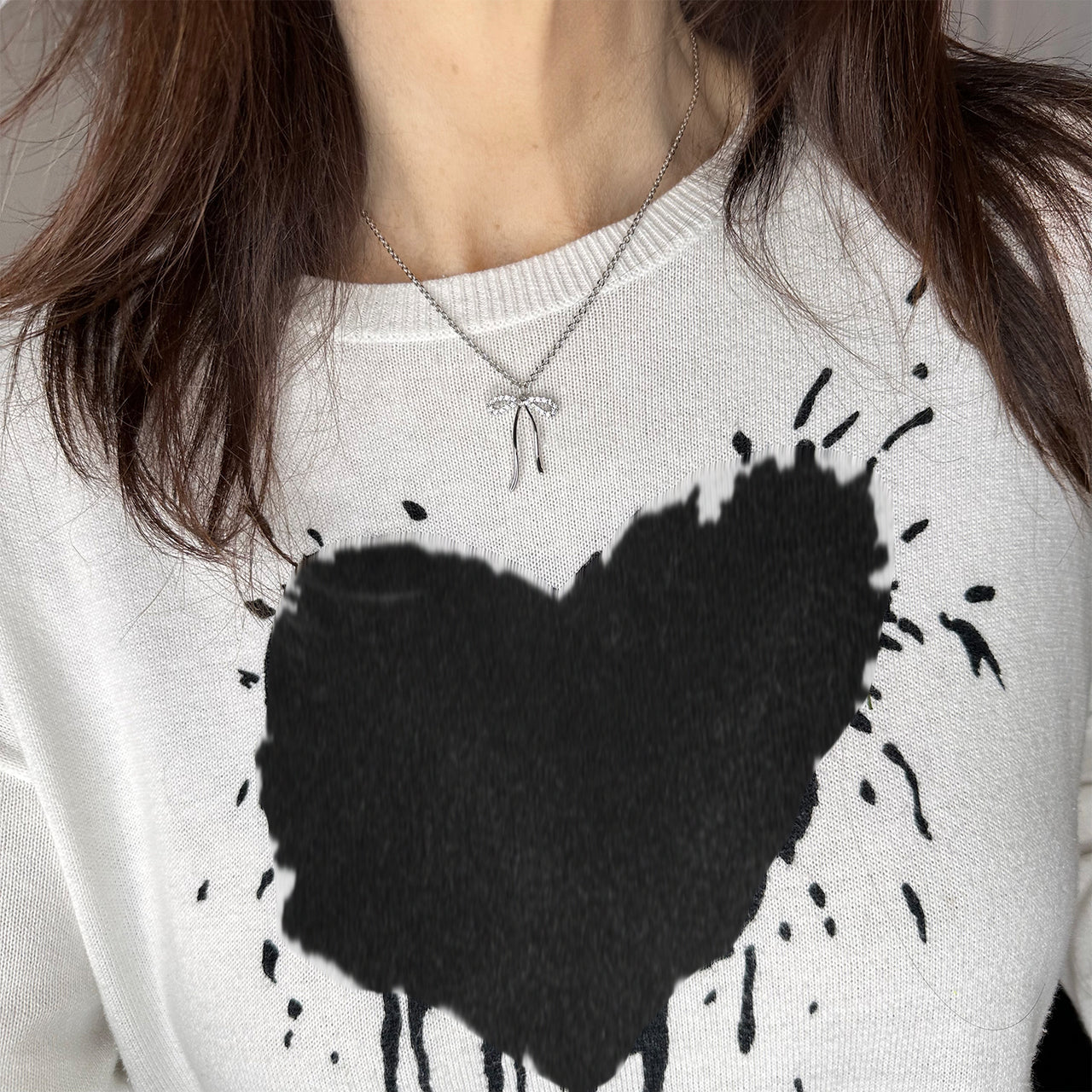 love lisa famous ribbon bow necklace styled on model with t shirt