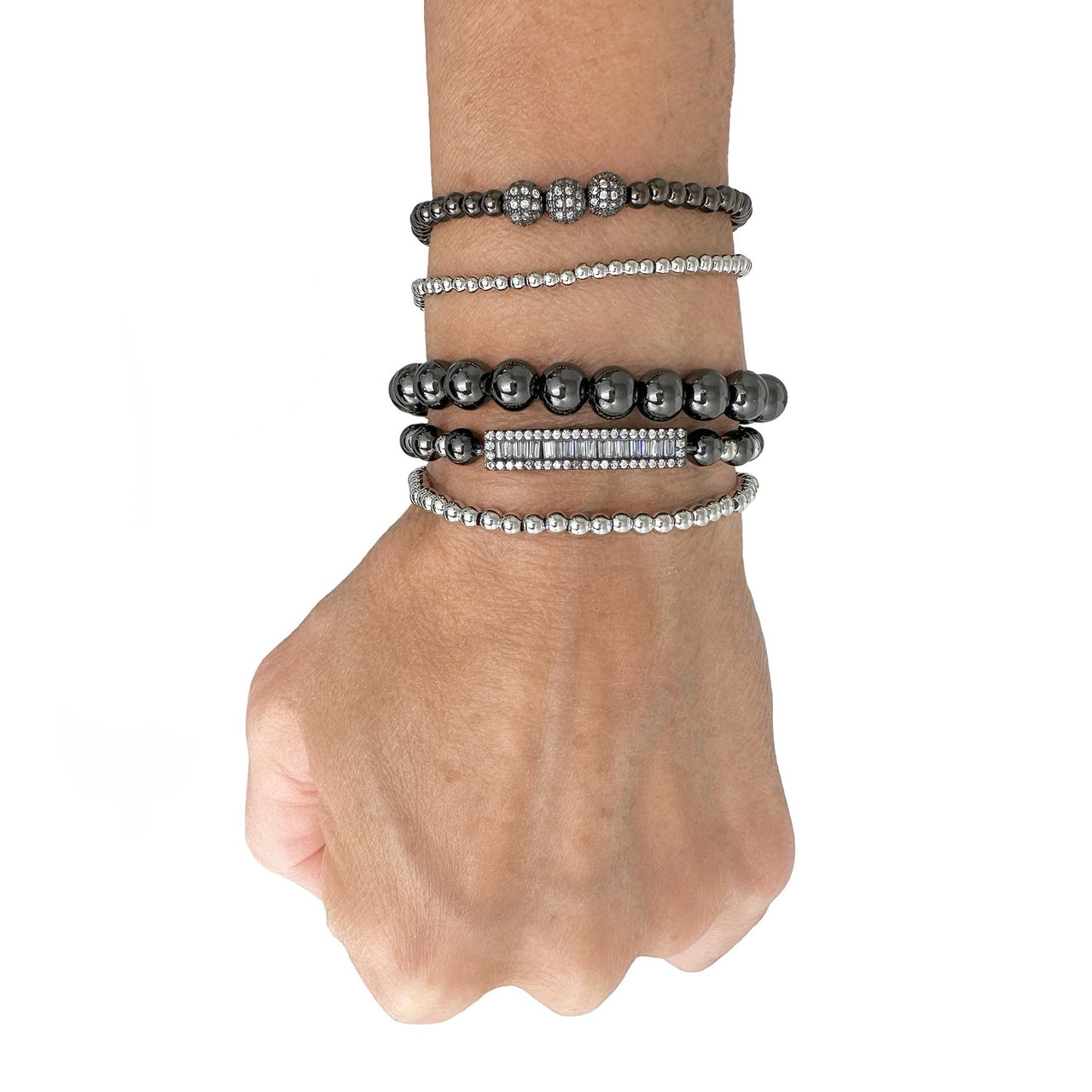love lisa fancy celebrity five stack bracelet collection styled on wrist gold and gunmetal beaded bracelets