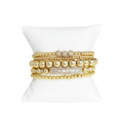 love lisa fancy celebrity five stack bracelet collection gold stack of beaded and pave bracelets on pillow
