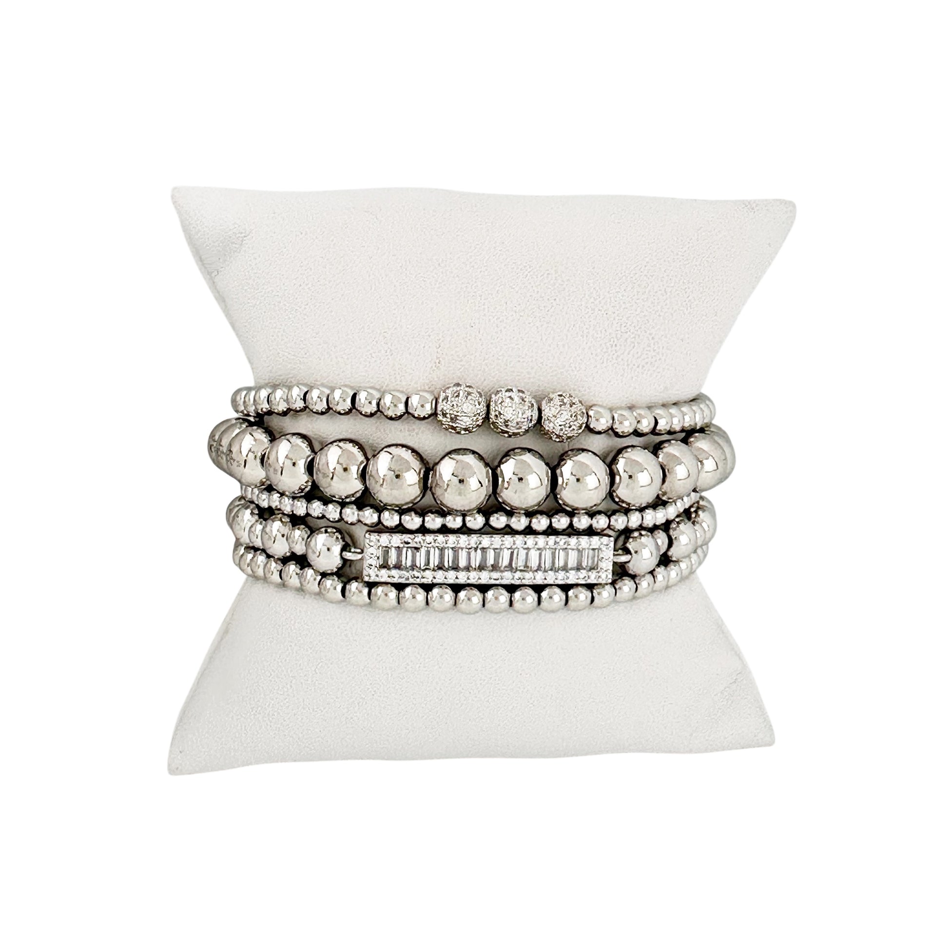 love lisa fancy celebrity five stack bracelet collection silver beaded and baguette bracelets on pillow
