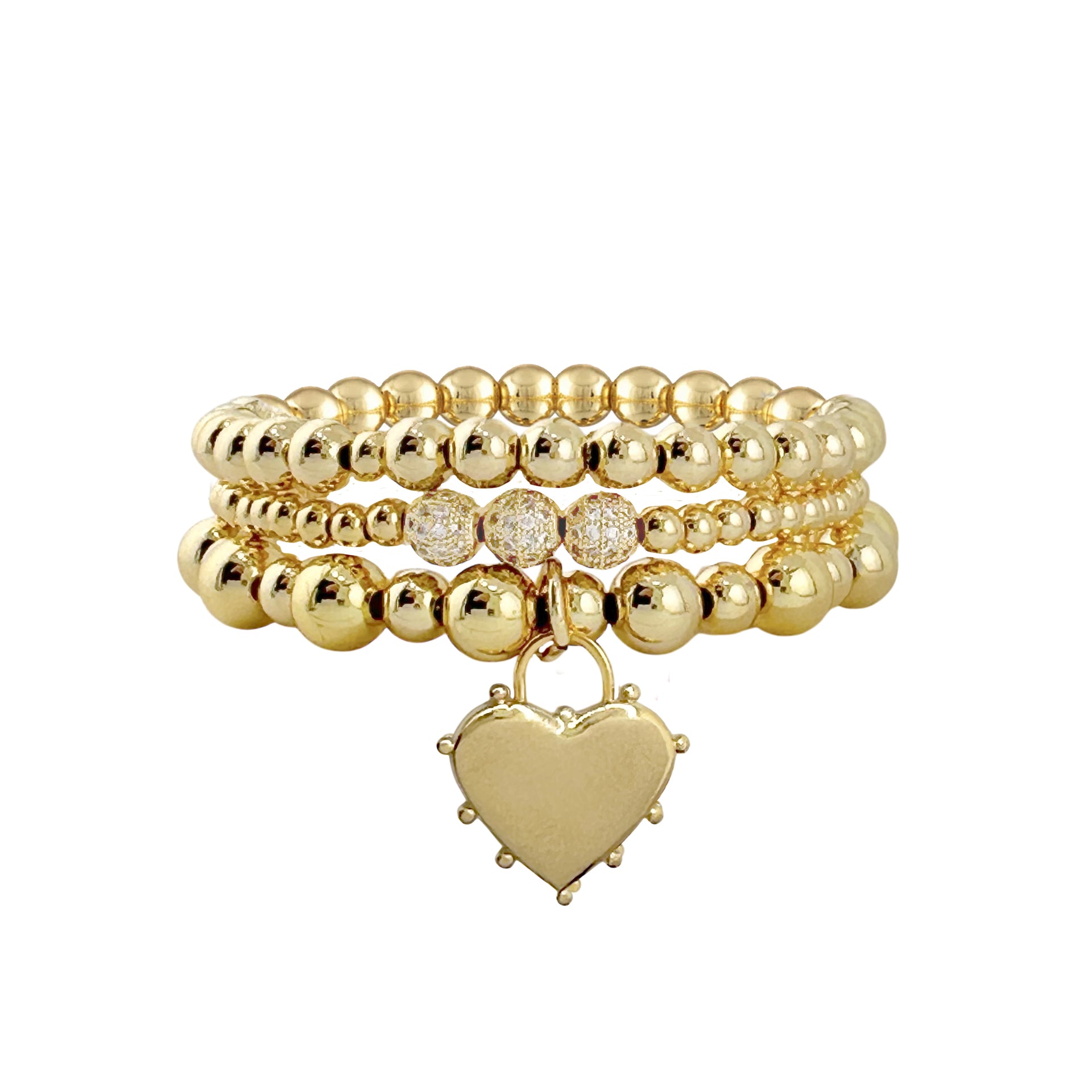 A gold bracelet stack featuring a series of round beads and a heart-shaped charm.