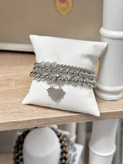 love lisa farah heart bracelet stack on pillow
