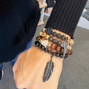 love lisa feather buddha gemstone wrap bracelet stacked on wrist earthy jasper and wood beads with feather and buddha charms
