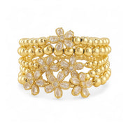 Elegant gold floral bracelet stack with crystal petal flowers