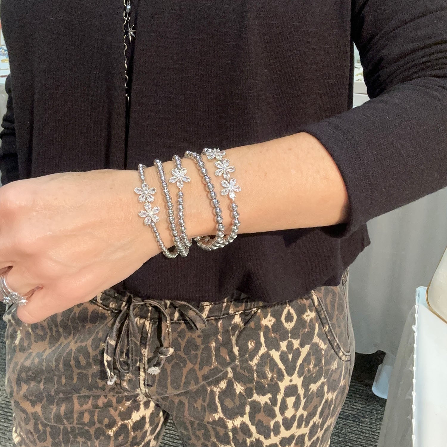 Felicity Floral Collection stretch bracelet with sparkling flower design in gold on model