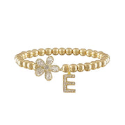 gold felicity flower initial charm bracelet with crystal flower charm and pave e letter charm on gold beads