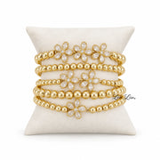 Elegant gold floral bracelet stack with crystal petal flowers