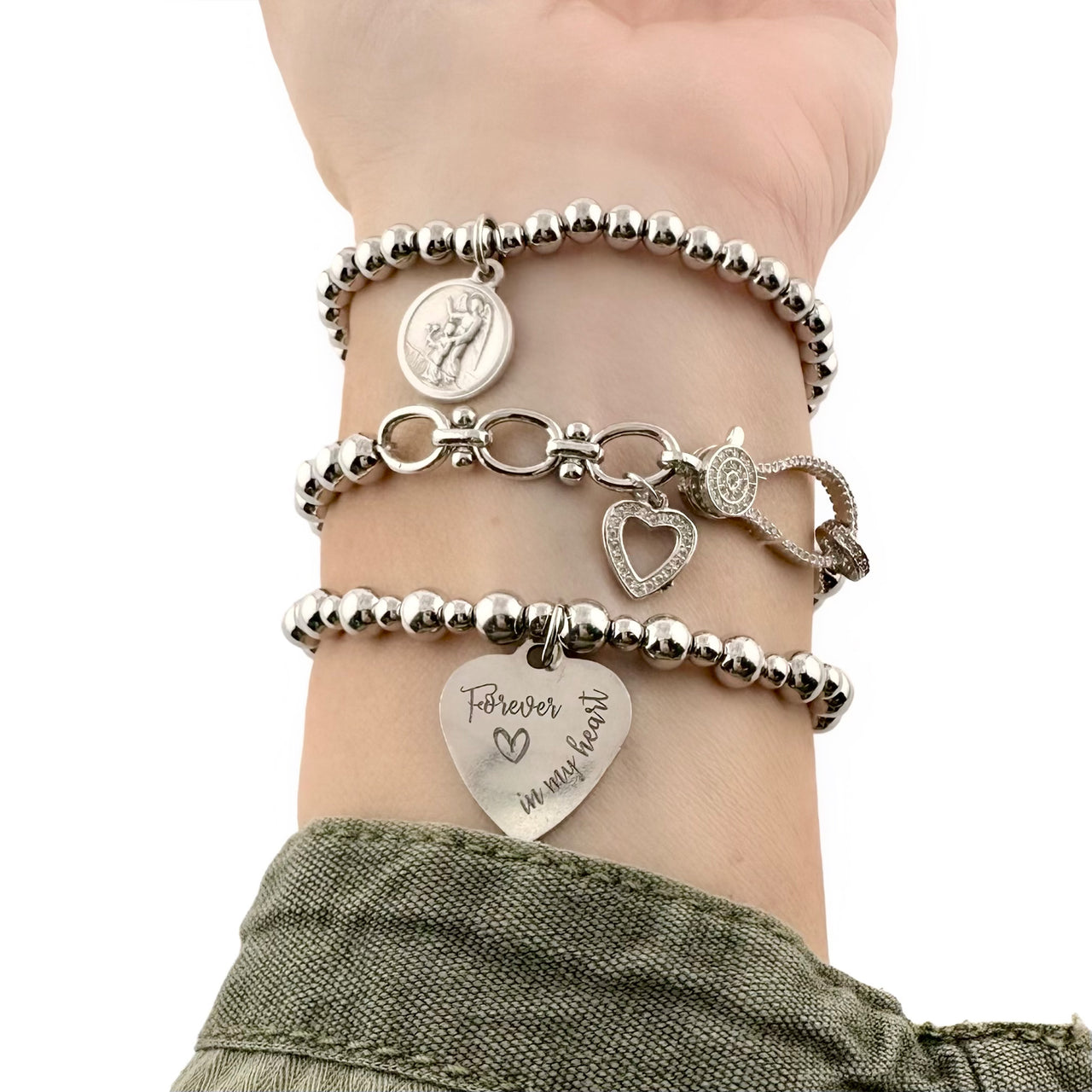 Silver-tone bracelet stack with heart charms and engraved “Forever in my heart” charm