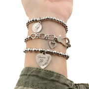 Silver-tone bracelet stack with heart charms and engraved “Forever in my heart” charm