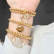 Love Lisa lock and key heart charm stretch bracelets worn stacked on wrist meaningful jewelry