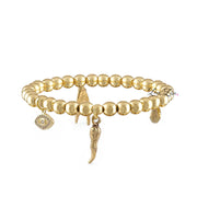 Gold beaded bracelet with charms on a white background