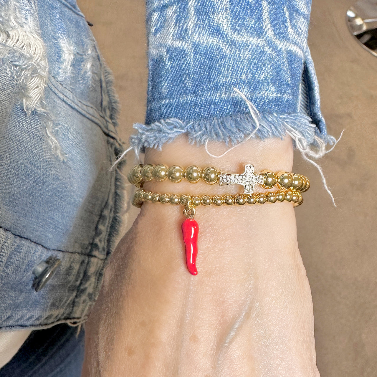 Hand modeling the 4mm beaded gold horn bracelet.