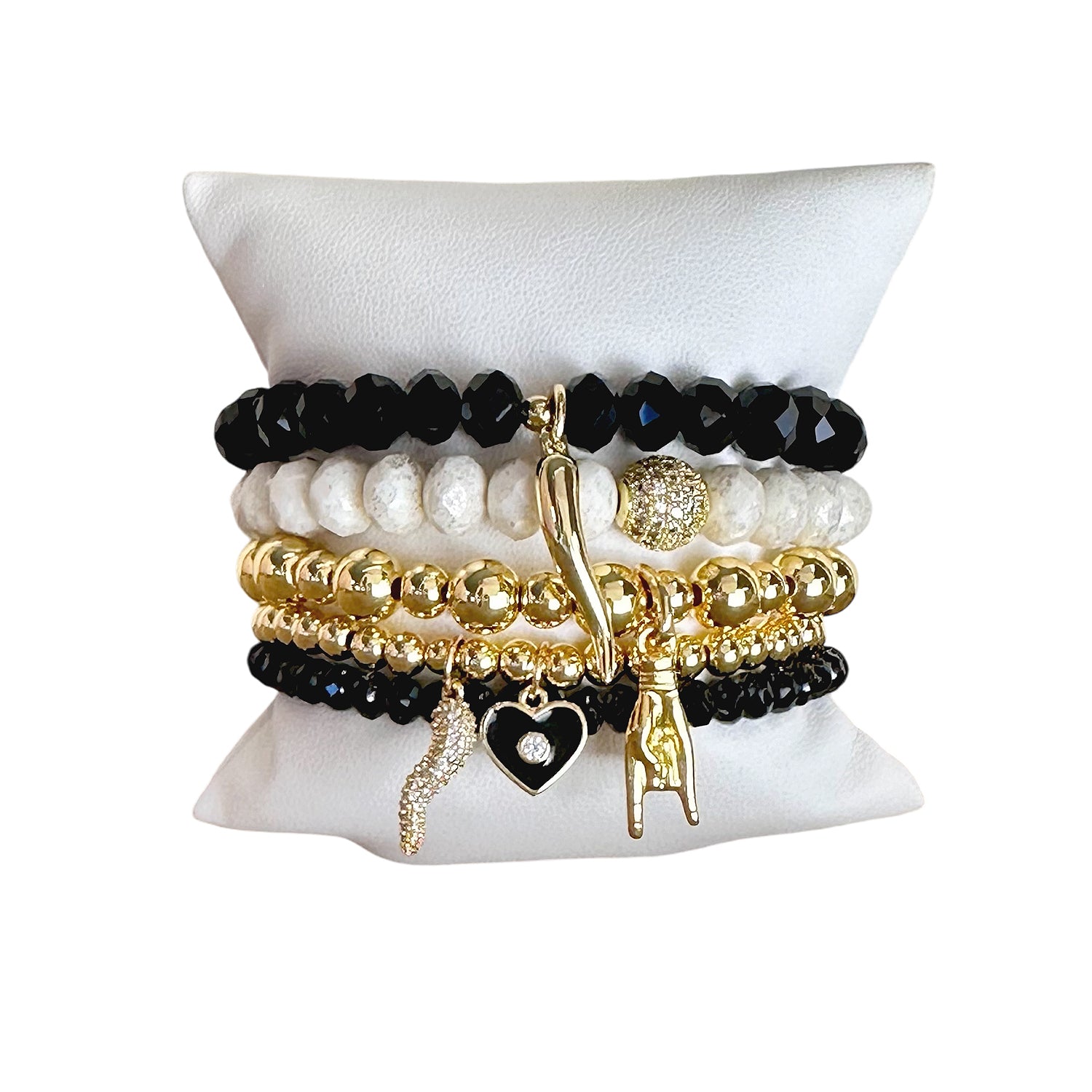 A set of beaded bracelets with gold, black, and white colors, featuring Italian horn charms and other decorative elements.