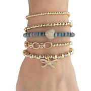 love lisa bow charm bracelets stacked with beaded bangles layered gold and silver jewelry for women
