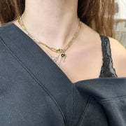 model wearing Giovanni necklace with red horn and gold paperclip chain