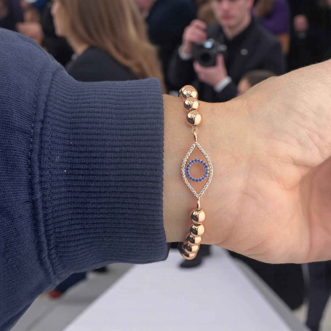 glam evil eye bracelet silver worn on model stacked with bracelets love lisa