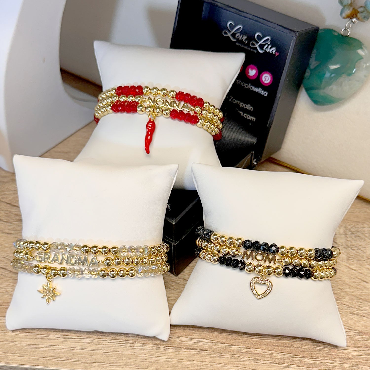 love lisa family bracelet stack display featuring mom heart grandma starburst and nonna italian horn charms gold beaded jewelry