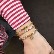 model wearing love lisa gold glam family bracelet stack with grandma charms and meaningful star charm